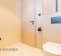 A bathroom in a family house with minimalist fixtures and light-colored walls.
