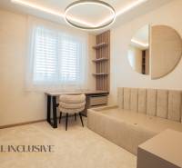Interior of a family house with a desk, chair, and modern lighting.