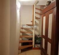 A spiral staircase with a wooden decor in a family house.