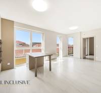 Interior of a 2-room apartment with large windows and light-colored walls.