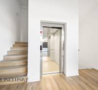 Elevator with stairs, floor with wooden decor, 2-room apartment.