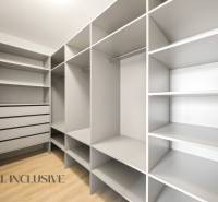 Wardrobe with shelves and drawers, floor with wood decor, 2-room apartment.