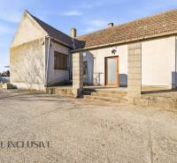 Exterior of commercial premises in Jelka with a concrete yard and a sloped roof.