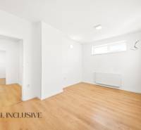 Commercial spaces with white walls and wood-patterned flooring.