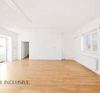 Spacious commercial spaces with white walls and a floor with a wooden decor.