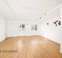 Commercial premises with a wooden decor floor and white walls.