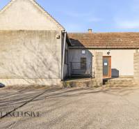 Commercial premises in Jelka with a simple facade and a concrete sidewalk.