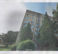 Apartment building with many windows and trees in front of it on T.G. Masaryk Street in Nové Zámky.