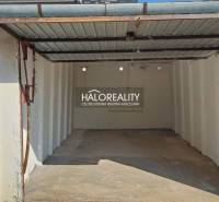 An uncovered garage in Senec with a low ceiling and a metal roof.