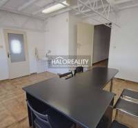 An office interior with ceramic flooring, a desk and chairs, a sink by the wall.