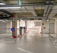 Underground garage with a ramp, lighting, and technical installations.
