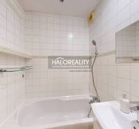 Bathroom in a 2-room apartment with a shower and a bathtub, bright tiles.