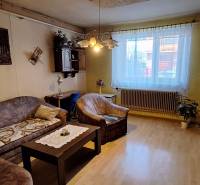 Living room in a family house with a wooden-decor floor and a sofa.