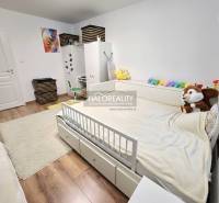 Children's room with a bed and white furniture, floor with wooden decor, 3-room apartment.