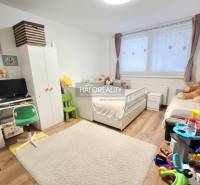 Children's room with white furniture, carpet and floor with wood decor in a 3-room apartment.
