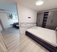 Entrance hall in a 2-room apartment with a wooden decor floor and a wardrobe.