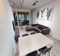 Bathroom with a round mirror and sink in a 2-room apartment.