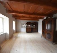Wooden ceiling, floor with wooden decor, and massive cabinets in the cabin.