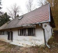 A cottage in Hodruša - Hámre with a wooden roof and forest surroundings.