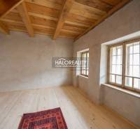 The interior of the cabin with a wood-decorated floor and wooden ceiling.