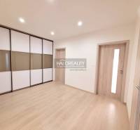 Interior of a 3-room apartment with a wooden decor floor and built-in wardrobes.