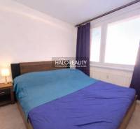 Bedroom in a 3-room apartment with a double bed, curtains, and a nightstand.