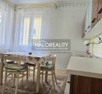 A kitchen unit in a family house with a wooden decor and a dining table.