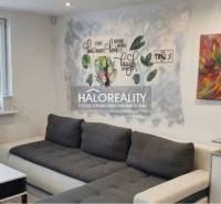 Living room in a 3-room apartment with a comfortable sofa and a decorative wall.