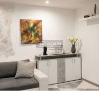 Living room in a 3-room apartment with modern wall decoration and a comfortable sofa.
