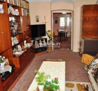Living room of a family house with a wooden wall unit and cozy furnishings.