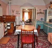 A kitchen full of vintage furniture and decorations offers a cozy space in a family home.