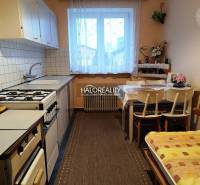Kitchen in a 2-room apartment with a kitchen table and a gas stove.