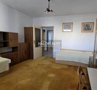A room in a 3-room apartment with wooden decor furniture and two beds.