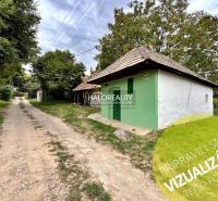 A country house in Záhrady near Mýtne Ludany, surrounded by trees and a gravel road.