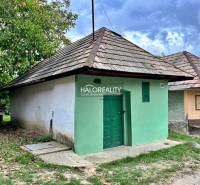 Old houses in Záhrady Mýtnych Ludan, with green and ochre facades.