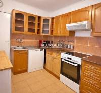 A kitchen in a 4-room apartment with a wooden floor decor and a kitchenette.