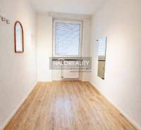 A bright room with a wooden decor floor in a 4-room apartment.