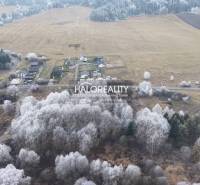 Snow-covered recreational lands in Liptovský Ján with forest stands and agricultural landscape.