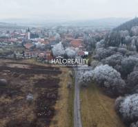 Winter landscape in Liptovský Ján with a view of recreational grounds and a snowy forest.