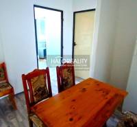 Dining table and chairs, classic design, wooden decor flooring in a 2-room apartment.