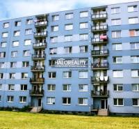 Apartment building with balconies and greenery in Liptovský Mikuláš, suitable for a 2-room apartment.