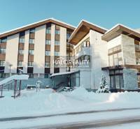 Snow-covered hotel and guesthouse buildings in the village of Vyšná Boca in winter.