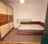 Bedroom with a double bed and a large wardrobe in a studio apartment.