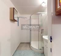 A bathroom in a 3-room apartment with a corner shower and tiles.