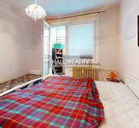 A room in a 3-room apartment with beds, a painting, and access to a balcony.