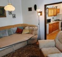 Living room with a sofa, entrance to the kitchen in a 3-room apartment.