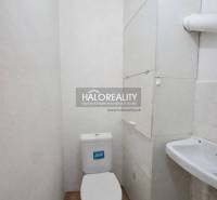 A small bathroom in a 4-room apartment with a toilet and a hanging cabinet.