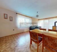Living room in a family house with a wooden decor floor and a dining table.
