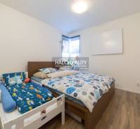 Bedroom in a 3-room apartment with a double bed and a children's bed, floor with wooden decor.
