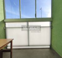 A glazed balcony in a 3-room apartment with a view and a table.